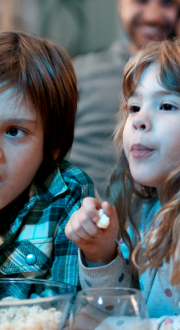 Family watching TV together at home