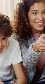 Woman and child having fun playing a video game