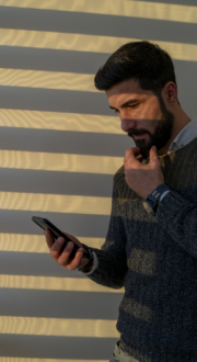 Man looking at mobile phone worried.