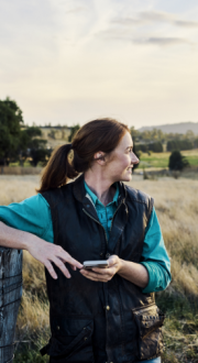 Young farmer staying in touch via mobile technology from their rural farm
