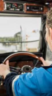 Truck driver with hands on steering wheel