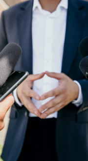 Person being interviewed by journalists 
