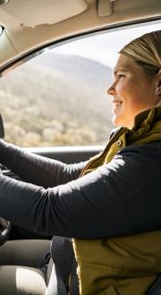 Person in the driver’s seat of a car driving.