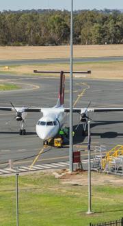 Image of regional Australian airport with turboprop plane on tarmac 