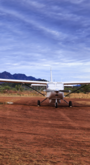 Three light aircraft on a remote Australian airstrip.