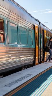 Passengers leave the train after it arrives at the station.