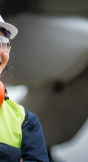 Woman maintenance engineer at the airport with PPE personal safety equipment is inspection airplane engineer portrait show.