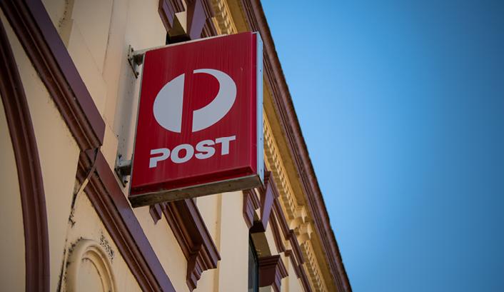 Australia Post sign on the side of a heritage building.