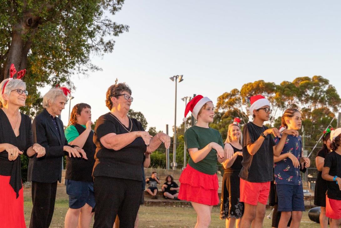 Photo of the Festive Auslan Choir performing at the at the Movies by Moonlight event in Burekup. Photo credit: Shire of Dardanup, WA.