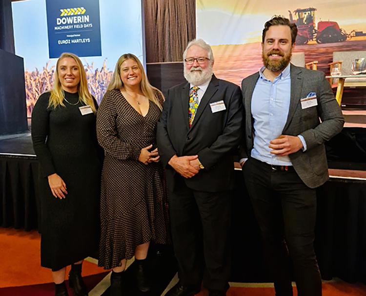 Photo showing four adults smiling at a conference. From left to right, Carly Filby (Community Relations Coordinator, Green Wind Renewables), Pauline Bantock (President, Shire of Victoria Plains), Sean Fletcher (CEO, Shire of Victoria Plains), and Daniel Cotter (Director of Development, Green Wind Renewables).
